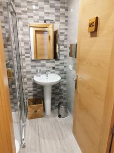 a bathroom with a sink and a mirror at La Casa del Hilario in Milagro