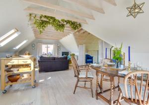 a kitchen and living room with a table and chairs at Blackthorn Barn in Goudhurst