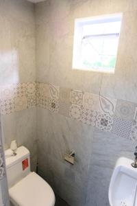 a bathroom with a toilet and a sink at J & J Homestay in Coron