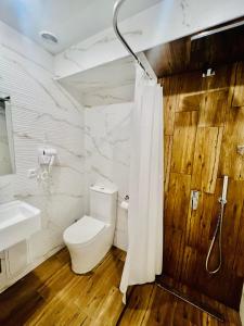 a bathroom with a toilet and a sink at Fortune Hotel in Yerevan