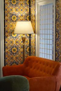 a living room with a couch and a lamp at La Menara Hotel & SPA in Sidi Bou Saïd