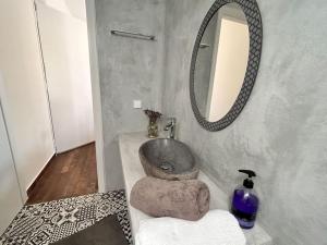 a bathroom with a sink and a mirror at Santa's Luxury Apartment in Tinos +21 photos