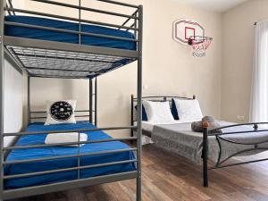 a bedroom with two bunk beds and a basketball hoop at Santa's Luxury Apartment in Tinos