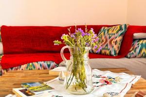 a vase of flowers on a table in a living room at Santa's Luxury Apartment in Tinos