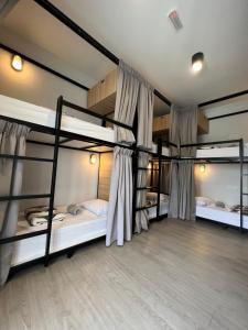 a room with three bunk beds in it at The Freedom Club Hostel KL in Kuala Lumpur