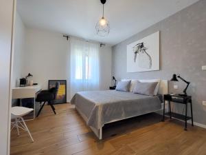 a bedroom with a bed and a desk and a chair at Central rooms in Šibenik