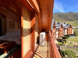 a wooden balcony with a view of a town at Apartament La Noguera in Rialp