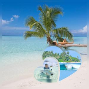 a photo of a person on a beach with a palm tree at Finimas Residence in Thimarafushi
