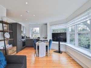 a kitchen and dining room with a table and chairs at Pass the Keys Luxury 1 Bed Flat on Windsor Riverside in Windsor