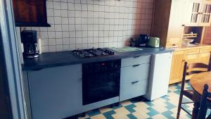 a kitchen with a stove and a counter top at Maison de 3 chambres avec jardin clos et wifi a Charix in Charix
