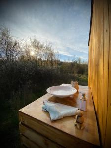 a bathroom sink sitting on a wooden deck with a view at Maringotka Za Trnkou 
