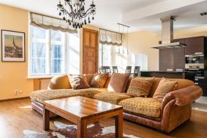 a living room with a couch and a table at Old Town - Oleviste Apartment in Tallinn