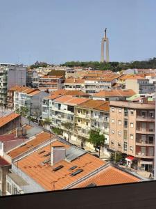 an overhead view of a city with buildings and roofs at Cozy Apartment in central Almada w Swing Chairs in Almada