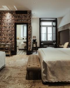 a bedroom with a large bed and a desk at AlmaLusa Baixa/Chiado in Lisbon