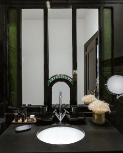 a bathroom with a sink and a mirror at AlmaLusa Baixa/Chiado in Lisbon
