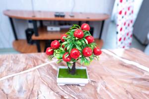 a vase filled with red fruit on a table at The Bliss - Lovely 1 bedroom apartment located near TRM mall in Nairobi