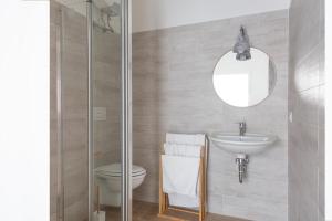 a bathroom with a sink and a toilet and a mirror at Lovin Puglia Vacation in Bari