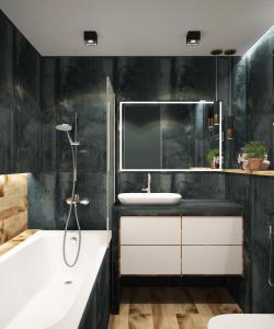 ein Badezimmer mit einer Badewanne, einem Waschbecken und einem Spiegel in der Unterkunft Bold Lab Studio 
