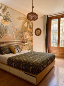 a bedroom with a large bed with a flamingo wallpaper at SabiaNatura - boutiqueMadrid in Madrid