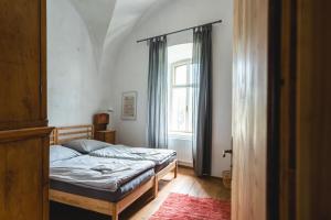 a bedroom with a bed and a window at Schloss Hornegg in Preding