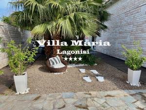 a sign for a marina lagoon with a bench and palm trees at Villa Maria Lagonissi - Private first floor Villa in Kalívia Thorikoú