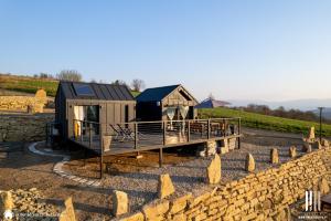 une petite maison sur un quai à côté d'un mur de pierre dans l'établissement Moon Hill's Lord, à Jeżów Sudecki