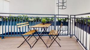 a wooden table and two chairs on a balcony at ALON HOMES Vienna - Premium Apartments City Center - Contactless Self-Check-In in Vienna