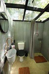 a small bathroom with a toilet and a sink at The Warren - Cosy Shepherds Hut in beautiful wild meadow in Halesworth