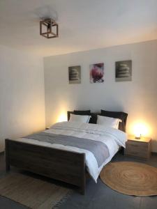 a bedroom with a large bed with two lamps on it at L'Escapade Urbaine - Montignies-sur-Sambre in Charleroi