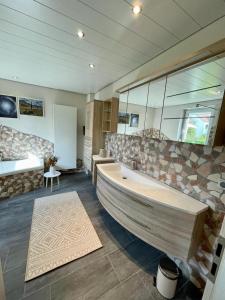 un ampio bagno con una grande vasca in una stanza di Maintal Relax a Michelau