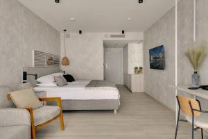a bedroom with a bed and a living room at GRANO HOTEL Solmarina in Wiślinka