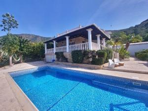 a house with a swimming pool in front of a house at Pomos Harbourbiew Villa in Pomos