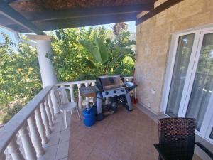 a balcony with a table with a tv on it at Pomos Harbourbiew Villa in Pomos