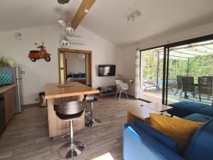 uma sala de estar com um sofá azul e uma mesa em PAUSE NATURE Maison Cosmos avec parking gratuit em Lapeyrouse-Fossat