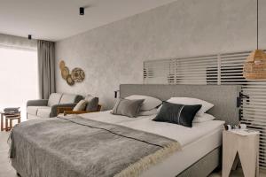 a bedroom with a large bed and a living room at GRANO HOTEL Solmarina in Wiślinka