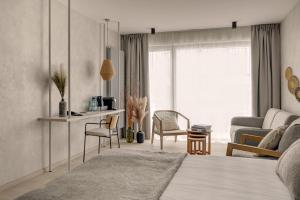 a bedroom with a bed and a living room at GRANO HOTEL Solmarina in Wiślinka