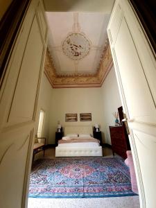 a bedroom with a bed and a chandelier at B&b RARO' LIBERTY in Lecce