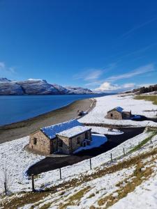 an aerial view of two buildings in the snow at The Wreck - Lochside cottage Dog Friendly in Ullapool