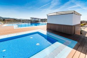 a swimming pool on the roof of a building at Apartaments Condado by Marsol in Lloret de Mar