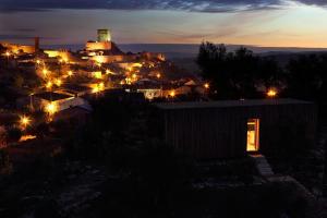 a city lit up at night with lights at Casas Do Coro in Marialva