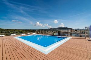 a swimming pool on the roof of a building at Apartaments Condado by Marsol in Lloret de Mar