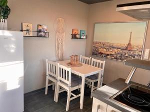 a kitchen with a table and chairs in a room at Maintal Relax in Michelau +9 photos