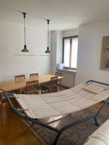 a bed in a room with a table and chairs at Attico in centro in Udine