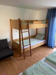 a room with two bunk beds and a chair at Apartment FIVE - EP Ticket Garantie in Rust +8 photos