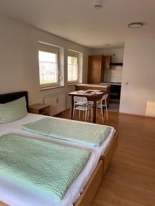 a bedroom with a bed and a kitchen with a table at Apartment FIVE - EP Ticket Garantie in Rust