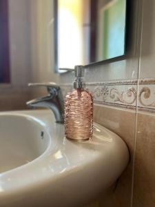 un dispensador de jabón sentado en la parte superior de un lavabo en Residenza Sinis, en Cabras
