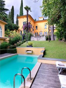an estate with a swimming pool in front of a house at Villa Ella in Luxury Resort in Gardone Riviera
