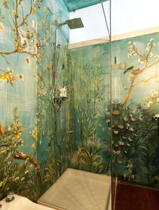 a bathroom with a mural of plants on the wall at Villa Ella in Luxury Resort in Gardone Riviera