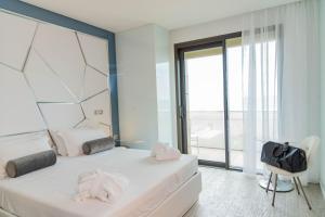 a bedroom with two beds and a large window at The Promenade Luxury Wellness Hotel in Riccione