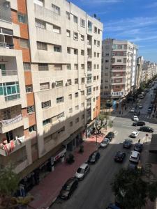 a city street with cars parked in front of buildings at Cœur de ville in Kenitra